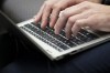 A person types on a laptop computers as President of the Treasury Board Anita Anand speaks during an Artificial Intelligence roundtable attended by AI experts and leaders from across Canada in Gatineau, Que., on Monday, May 27, 2024. THE CANADIAN PRESS/Sean Kilpatrick