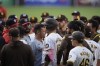 San Diego Padres' Manny Machado, center, stands with other members of the Padres in front of Washington Nationals during an at-bat for Padres' Jurickson Profar during the first inning of a baseball game Tuesday, June 25, 2024, in San Diego. (AP Photo/Gregory Bull)
