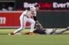 Cleveland Guardians' Steven Kwan, right, is safe after stealing second base in front of Baltimore Orioles shortstop Gunnar Henderson, left, during the second inning of a baseball game, Tuesday, June 25, 2024, in Baltimore. (AP Photo/Stephanie Scarbrough)