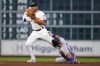 Houston Astros shortstop Jeremy Pena, left, looks to first after forcing out Colorado Rockies' Ezequiel Tovar during the fourth inning of a baseball game Tuesday, June 25, 2024, in Houston. Ryan McMahon advanced to second on the play on a throwing error by Pena. (AP Photo/Eric Christian Smith)