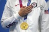 FILE - Katie Ledecky of the United States with her gold medal after winning the women's 1500-meters freestyle final at the 2020 Summer Olympics, on July 28, 2021, in Tokyo, Japan. The United States is strongly favored to win the most overall medals when the Paris Olympics open in a month. The big question is this: will the Americans also top the gold-medal tally in a close race with China? (AP Photo/Matthias Schrader, File)