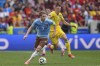 Belgium's Kevin De Bruyne, left, fights for the ball with Ukraine's Vitaliy Mykolenko during a Group E match between Ukraine and Belgium at the Euro 2024 soccer tournament in Stuttgart, Germany, Wednesday, June 26, 2024. (AP Photo/Ariel Schalit)