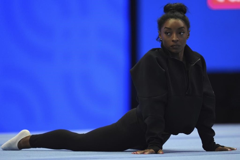 Simone Biles stretches during a training session ahead of the U.S. Gymnastics Olympic Trials Wednesday, June 26, 2024, in Minneapolis. (AP Photo/Abbie Parr)