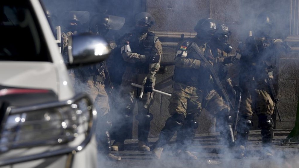 Military Police stand amid tear gas they fired outside the presidential palace in Plaza Murillo in La Paz, Bolivia, Wednesday, June 26, 2024. (AP Photo/Juan Karita)