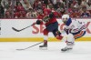 Florida Panthers center Sam Reinhart, left, aims the puck for a goal as Edmonton Oilers center Leon Draisaitl (29) attempts to defend during the second period of Game 7 of the NHL hockey Stanley Cup Final, Monday, June 24, 2024, in Sunrise, Fla. (AP Photo/Wilfredo Lee)