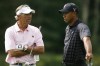 FILE - Tiger Woods, right, talks with Seth Waugh during the pro-am round of the Deutsche Bank Championship golf tournament in Norton, Mass., Thursday, Sept. 3, 2009. Waugh, the former CEO of Deutsche Bank Americas, became CEO of the PGA of America in 2018 and has decided to step down after six years. (AP Photo/Stew Milne, File)