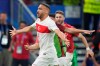 Turkey's Cenk Tosun, front, celebrates after scoring his side's second goal during a Group F match between Czech Republic and Turkey at the Euro 2024 soccer tournament in Hamburg, Germany, Wednesday, June 26, 2024. (Marcus Brandt/dpa via AP)