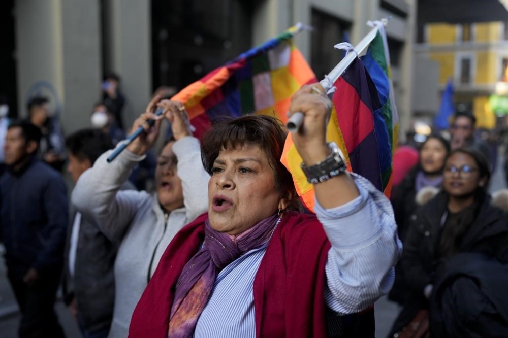 A supporter of Bolivian President Luis Arce enters Plaza Murillo after a failed coup, in La Paz, Bolivia, Wednesday, June 26, 2024. Armored vehicles rammed the doors of Bolivia's government palace Wednesday in an apparent coup attempt against Arce, but he vowed to stand firm and named a new army commander who ordered troops to stand down. (AP Photo/Juan Karita)