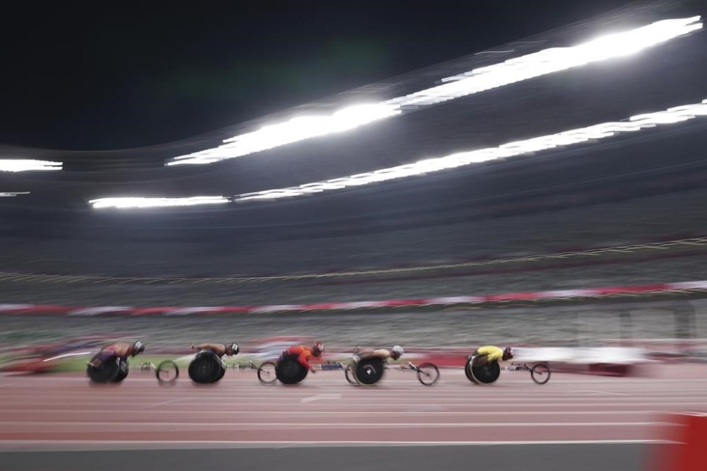 FILE - Athletes compete during men's T54 5000m heat at Tokyo 2020 Paralympic Games, Friday, Aug. 27, 2021, in Tokyo, Japan. With two months left before the start of the Paralympics in Paris, organizers said Thursday, June 27, 2024, that one million tickets have been sold. That is still only just above a third of the 2.8 million tickets available for the Aug 28-Sept. 8 Paralympic Games. (AP Photo/Eugene Hoshiko, File)