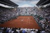 Russia's Daniil Medvedev, near side, plays a shot against Australia's Alex De Minaur during their fourth round match of the French Open tennis tournament at the Roland Garros stadium in Paris, Monday, June 3, 2024. (AP Photo/Christophe Ena)