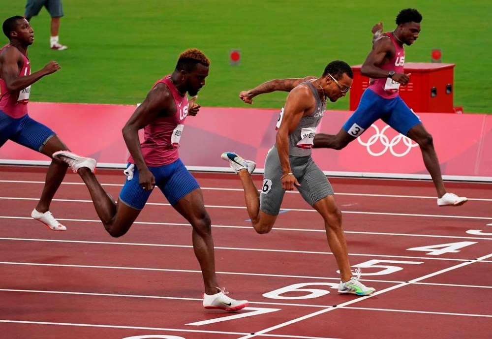 FILE - Andre De Grasse, of Canada, races to win the gold medal ahead of Kenneth Bednarek, foreground, of the United States, silver, and Noah Lyles, right, of the United States, bronze, in the final of the men's 200-meters at the 2020 Summer Olympics, Wednesday, Aug. 4, 2021, in Tokyo, Japan. De Grasse manages to stay under the radar most of the time, but has a knack for turning up big when the lights are shining the brightest. (Nathan Denette/The Canadian Press via AP, File)