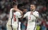 England's Bukayo Saka, center, is comforted after he missed to score the last penalty during the penalty shootout of the Euro 2020 soccer championship final between England and Italy at Wembley stadium in London, Sunday, July 11, 2021. The penalty shootout is a tense battle of wills over 12 yards (11 meters) that has increasingly become a huge part of soccer and an unavoidable feature of the knockout stage in the biggest competitions. (AP Photo/Frank Augstein, Pool, File)