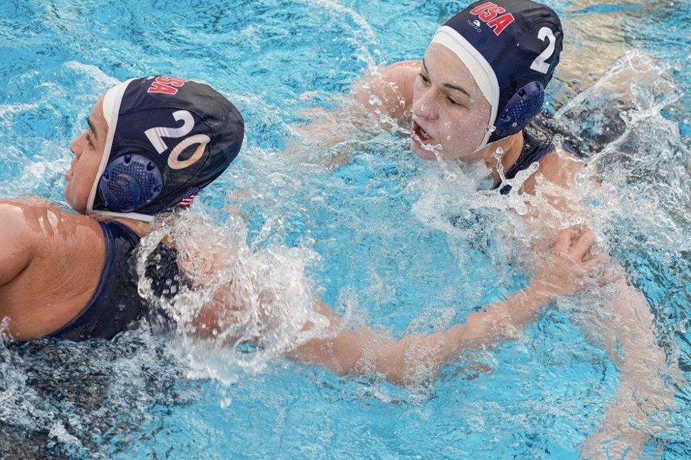 USA Water Polo Women's Senior National Team attacker Ryann Neushul, left, trains at Long Beach City College Thursday, Jan. 18, 2024, in Long Beach, Calif. Following in the footsteps of two older sisters who won gold with the U.S. women's water polo team, Ryann Neushul is making her Olympic debut in Paris this summer. (AP Photo/Damian Dovarganes)