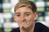 England's Anthony Gordon smiles during a press conference in Blankenhain, Germany, Friday, June 28, 2024 ahead of the round of 16 soccer match against Slovakia at the Euro 2024 soccer tournament. The Newcastle winger has fallen off his electric bicycle at the training camp of the national team gashing his chin and cutting his hands. (AP Photo/Thanassis Stavrakis)