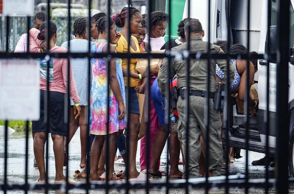 Migrants prepare to depart the U.S. Customs and Border Protection - Marathon Border Patrol Station in Marathon, Fla. on Wednesday, June 26, 2024. A group of more than 100 migrants from Haiti arrived off Key West in a sailboat early Wednesday morning, according to the Monroe County Sheriff's Office. (Al Diaz/Miami Herald via AP)