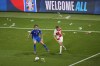 Croatia's Martin Erlic, right, and Italy's Riccardo Calafiori challenge for the ball as plastic cups and glasses litter the pitch during the Group B match between Croatia and Italy at the Euro 2024 soccer tournament in Leipzig, Germany, Monday, June 24, 2024. (AP Photo/Sergei Grits)