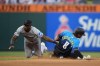 Philadelphia Phillies' Nick Castellanos, right, steals second past Miami Marlins shortstop Tim Anderson during the seventh inning of a baseball game, Friday, June 28, 2024, in Philadelphia. (AP Photo/Matt Slocum)
