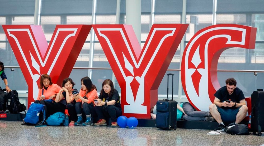 Travellers wait for flights at Calgary International Airport as WestJet mechanics strike in Calgary, Saturday, June 29, 2024. THE CANADIAN PRESS/Jeff McIntosh