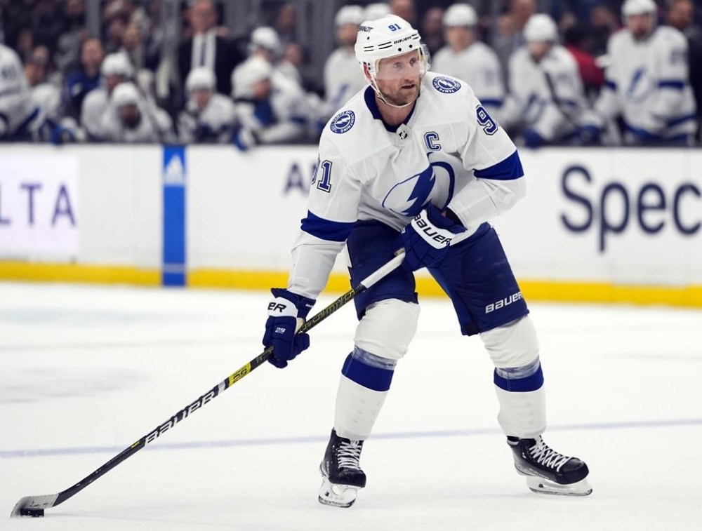 FILE - Tampa Bay Lightning center Steven Stamkos moves the puck during the third period of an NHL hockey game against the Los Angeles Kings, March 23, 2024, in Los Angeles. Stamkos is still on course to become a free agent even after the Lightning cleared significant salary cap space with trades made at the NHL draft. General manager Julien BriseBois and agent Don Meehan independently confirmed their stances have not changed with respect to Stamkos signing a new contract with the club before free agency opens Monday, July 1, 2024. (AP Photo/Jae C. Hong, File)