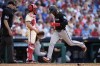 Miami Marlins' Otto Lopez, right, scores past Philadelphia Phillies catcher Garrett Stubbs on a double by Nick Fortes during the seventh inning of a baseball game, Saturday, June 29, 2024, in Philadelphia. (AP Photo/Matt Slocum)