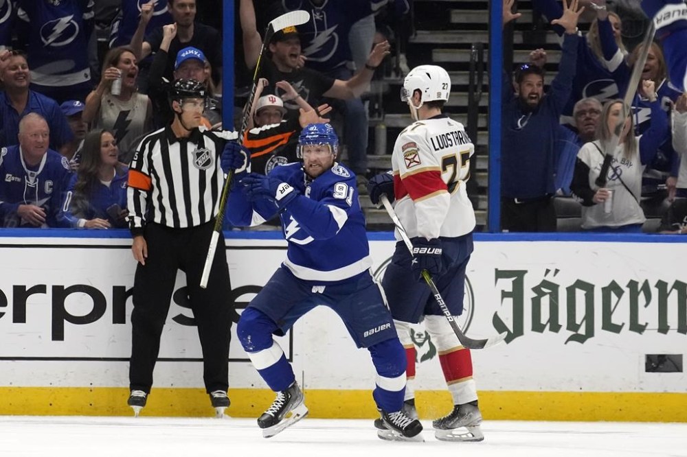 Tampa Bay Lightning center Steven Stamkos (91) celebrates his goal in front of Florida Panthers center Eetu Luostarinen (27) during the first period in Game 4 of an NHL hockey Stanley Cup first-round playoff series, Saturday, April 27, 2024, in Tampa, Fla. THE CANADIAN PRESS/AP-Chris O'Meara