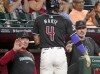 Arizona Diamondbacks' Ketel Marte (4) is greeted by bench coach Jeff Banister, left, and head coach Torey Lovullo, right, after scoring a run during the fourth inning of a baseball game against the Oakland Athletics, Sunday, June 30, 2024, in Phoenix. (AP Photo/Darryl Webb)