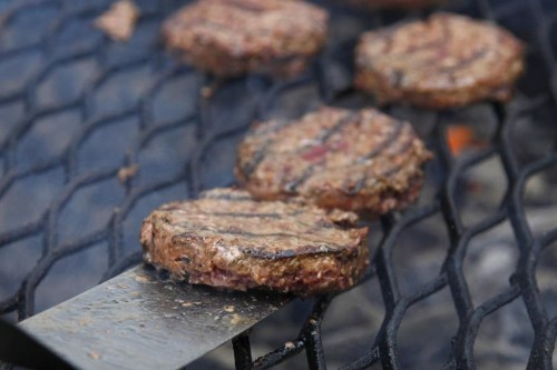 FILE - Hamburgers appear on a grill in Washington on Aug. 4, 2011. Most grillers recommend a mixture of 80% beef to 20% fat, but Craig “Meathead” Goldwyn, author of “Meathead, The Science of Great Barbecue and Grilling,” prefers even more fat, up to a 70:30 ratio. (AP Photo/Carolyn Kaster, File)