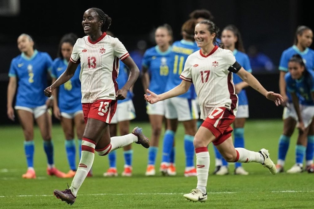Canada's Simi Awujo, left, and Jessie Fleming celebrate winning in a shootout against Brazil in a SheBelieves Cup women’s soccer game, Saturday, April 6, 2024, in Atlanta. Canada coach Bev Priestman unveils her 18-player roster for the Paris Olympics. The eighth-ranked Canadian women open defence of their Olympic title July 25 against New Zealand. THE CANADIAN PRESS/(AP/Mike Stewart