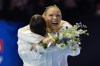 Jade Carey gets hugged by Jordan Chiles as the team is named for the 2024 Olympics at the United States Gymnastics Olympic Trials on Sunday, June 30, 2024, in Minneapolis. (AP Photo/Abbie Parr)