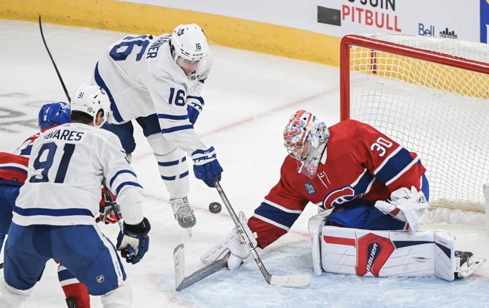 Toronto Maple Leafs' Mitch Marner (16) moves in on Montreal Canadiens goaltender Cayden Primeau as Leafs' John Tavares (91) looks on during third period NHL hockey action in Montreal, Saturday, April 6, 2024.A series of Canadian clashes will feature early in the NHL calendar next season, including a tilt between the Toronto Maple Leafs and Montreal Canadiens at the Bell Centre.THE CANADIAN PRESS/Graham Hughes