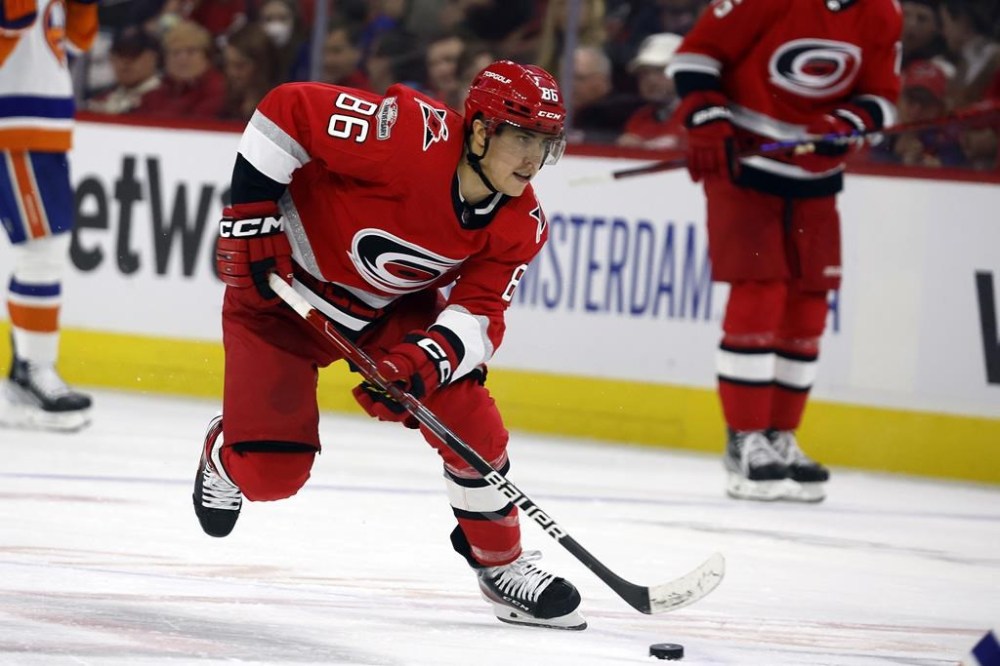 FILE - Carolina Hurricanes' Teuvo Teravainen (86) skates with the puck against the New York Islanders during the second period of Game 2 of an NHL hockey Stanley Cup first-round playoff series in Raleigh, N.C., Wednesday, April 19, 2023. Tyler Bertuzzi and Teuvo Teravainen have agreed to contracts with Chicago, providing a major offensive lift for the rebuilding Blackhawks on the first day of NHL free agency. Bertuzzi received a $22 million, four-year deal, and Teravainen’s agreement is worth $16.2 million over three seasons. (AP Photo/Karl B DeBlaker, FIle)