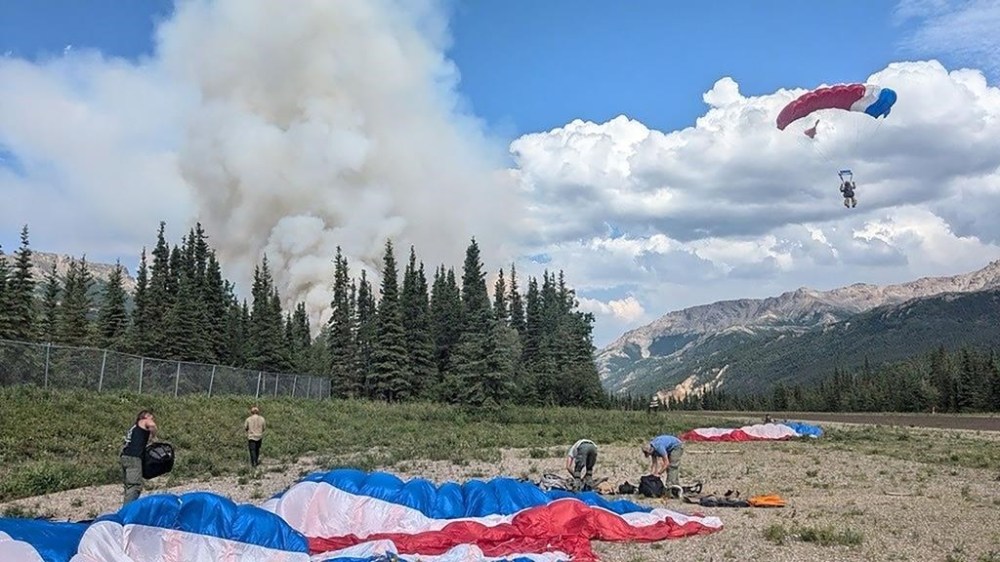 In this photo provided by the National Park Service smokejumpers arrive on scene in Denali National Park and Preserve to fight a wildfire burning about a mile north of the park's only entrance on June 30, 2024. The fire forced the temporary closure of the park on Monday, July 1, 2024. (National Park Service via AP)