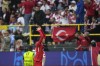 Turkey's Mert Muldur, left, celebrates after scoring his side's opening goal during a Group F match between Turkey and Georgia at the Euro 2024 soccer tournament in Dortmund, Germany, Tuesday, June 18, 2024. (AP Photo/Alessandra Tarantino)