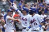 New York Mets' Brandon Nimmo, center, celebrates after hitting a home run during the seventh inning of a baseball game against the Houston Astros, Sunday, June 30, 2024, in New York. (AP Photo/Pamela Smith)