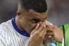 FILE - Kylian Mbappe of France holds his nose after suffering an injury during a Group D match between Austria and France at the Euro 2024 soccer tournament in Duesseldorf, Germany, on June 17, 2024. Kylian Mbappé has had more masks than goals at Euro 2024. Widely regarded as the heir to Lionel Messi and Cristiano Ronaldo as soccer's biggest icon, the France striker is struggling with his peripheral vision due to the protective face covering he has been fitted with since breaking his nose at the start of the European Championship. (AP Photo/Martin Meissner)