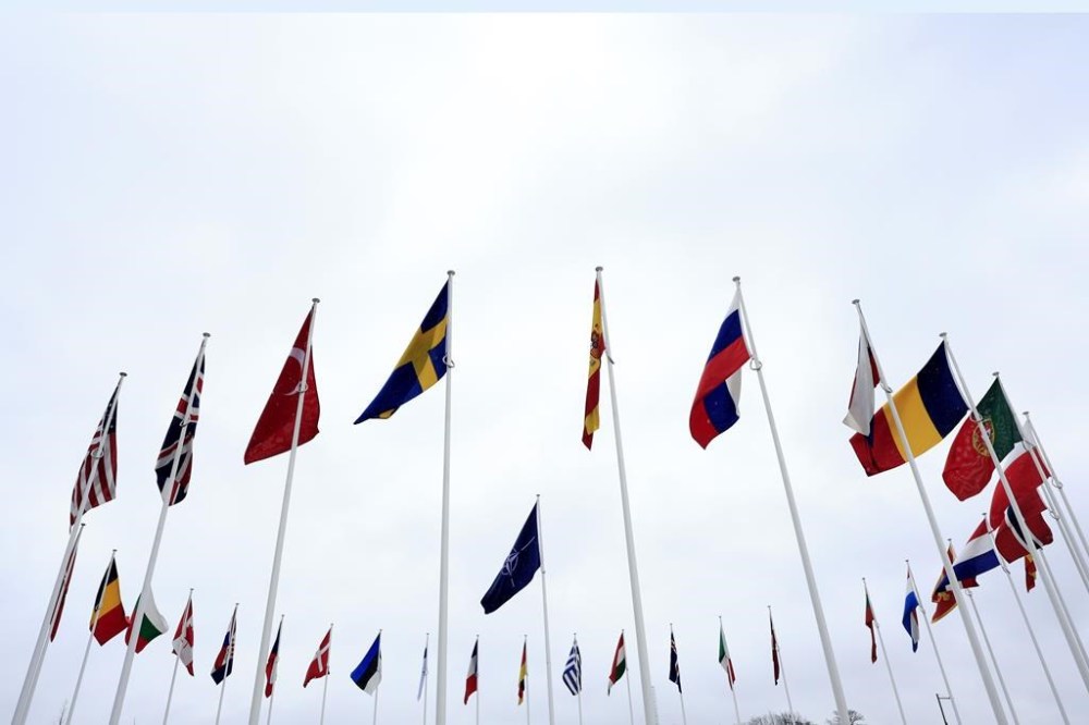 Prime Minister Justin Trudeau is heading to Washington, D.C., next week to take part in the NATO leaders' summit. The flag of Sweden, center left, flaps in the wind alongside other alliance member flags after a ceremony to mark the accession of Sweden to NATO at NATO headquarters in Brussels, Monday, March 11, 2024. THE CANADIAN PRESS/AP-Geert Vanden Wijngaert