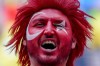 A Turkish fan celebrates prior to a round of sixteen match between Austria and Turkey at the Euro 2024 soccer tournament in Leipzig, Germany, Tuesday, July 2, 2024. (AP Photo/Darko Vojinovic)