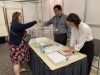 A French citizen, left, places their ballot in a ballot box as they turned out to vote in France's national elections, at the Centre Mont-Royal in Montreal, Saturday, June 29, 2024. THE CANADIAN PRESS/Joe Bongiorno