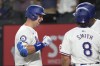 Texas Rangers Nathaniel Lowe, left, celebrates hitting a home run with Josh Smith (8) during the third inning of a baseball game against the San Diego Padres in Arlington, Texas, Tuesday, July 2, 2024. Rangers' Josh Smith also scored on the play. (AP Photo/LM Otero)