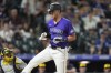 Colorado Rockies' Nolan Jones reacts after getting hit by a pitch from Milwaukee Brewers relief pitcher Rob Zastryzny in the eighth inning of a baseball game Tuesday, July 2, 2024, in Denver. (AP Photo/David Zalubowski)