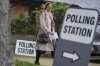 FILE - A woman holds her voting card as she arrives to vote in London in local elections, Thursday, May 2, 2024. U.K. voters are set to cast ballots in a national election on July 4, passing judgment on 14 years of Conservative rule. They are widely expected to do something they have not done since 2005 — elect a Labour Party government. (AP Photo/Kin Cheung, File)