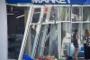 In this photo released by the Dnipro Regional Administration, people stand near shop windows damaged following Russia's missile attack in Dnipro, Ukraine, Wednesday, July 3, 2024. (Dnipro Regional Administration via AP)