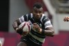 FILE - Fiji's Jerry Tuwai, center, evades Britain's Alex Davis as Fiji's Meli Derenalagi looks on, in their men's rugby sevens match at the 2020 Summer Olympics, on July 27, 2021 in Tokyo, Japan. Osea Kolinisau led Fiji to its first ever Olympic gold medal when rugby sevens made its debut at the Summer Games in 2016 and now, as a coach, he’s turning to old teammate Jerry Tuwai to help the Pacific nation’s bid for a three-peat. (AP Photo/Shuji Kajiyama, File)