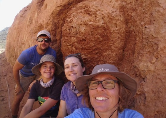 Stellenbosch University researcher, Michele Francis, right, and other researchers, pose for a selfie, next to an ancient termite mound in Namaqualand, South Africa. (Michele Francis photo / The Associated Press files)