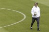 Switzerland's head coach Murat Yakin walks with a soccer ball on field during training at the 