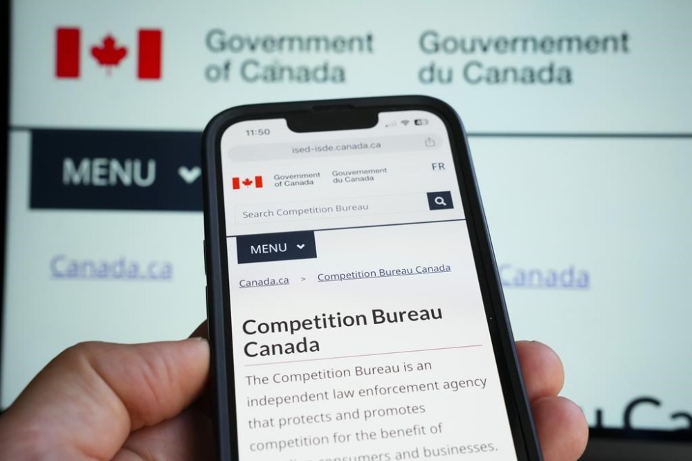 The Competition Bureau says it will speed the development of guidance on the interpretation of new provisions in the Competition Act aimed at greenwashing.The government's Competition Bureau website is pictures on a mobile phone and laptop screen in Ottawa on Monday, Oct. 2, 2023. THE CANADIAN PRESS/Sean Kilpatrick