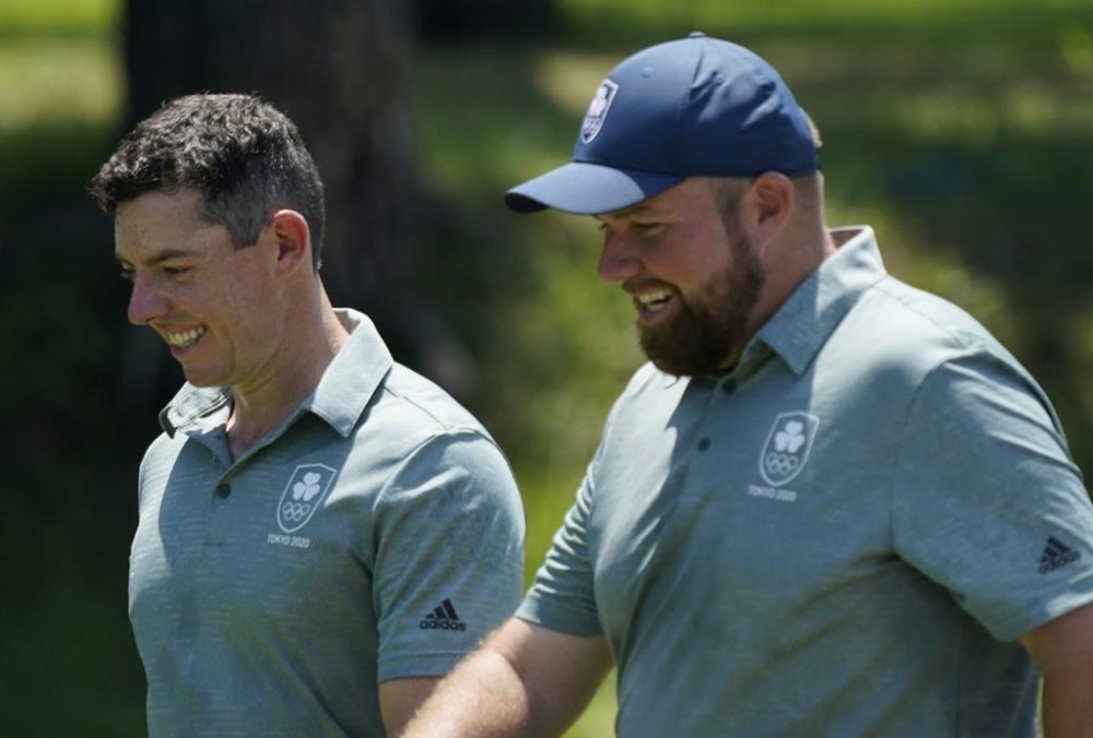 FILE - Ireland's Rory McIlroy and his teammate Shane Lowry speak during a practice round of the men's golf event at the 2020 Summer Olympics, Wednesday, July 28, 2021, at the Kasumigaseki Country Club in Kawagoe, Japan, McIlroy was indifferent about golf in the Olympics when it returned to the program in 2016. Now it's a priority to him.(AP Photo/Matt York, File)