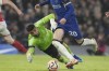 FILE - Chelsea's Cole Palmer goes with the ball past Arsenal's goalkeeper David Raya in an unsuccessful attempt to score during the English Premier League soccer match between Chelsea and Arsenal at Stamford Bridge stadium in London, England, Saturday, Oct. 21, 2023. Premier League runner-up Arsenal signed goalkeeper David Raya on a long-term contract Thursday, July 4, 2024 after he did well on loan from Brentford last season. (AP Photo/Frank Augstein, File)