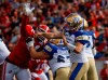 Winnipeg Blue Bombers' quarterback Zach Collaros (8) throws the ball under pressure from Calgary Stampeders' Mike Rose (41) during first half CFL football action in Calgary on June 29, 2024. THE CANADIAN PRESS/Jeff McIntosh