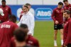Switzerland's head coach Murat Yakin center left, smiles during a training session of the Swiss national soccer team in Stuttgart, Germany, Tuesday, July 2, 2024. (Peter Klaunzer/Keystone via AP)